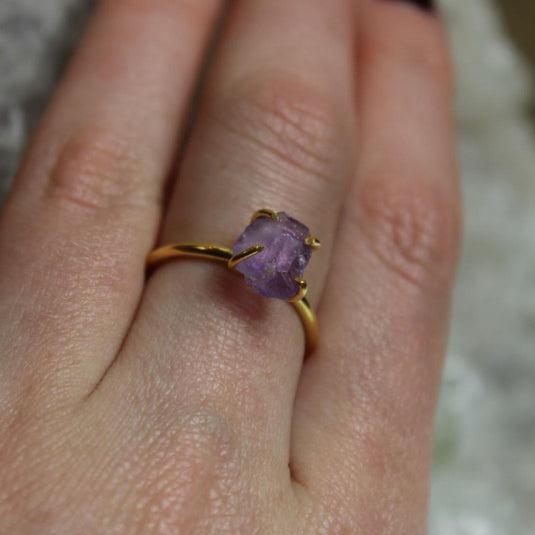 A close-up of a Raw Amethyst Ring set in 18ct gold vermeil on a hand.