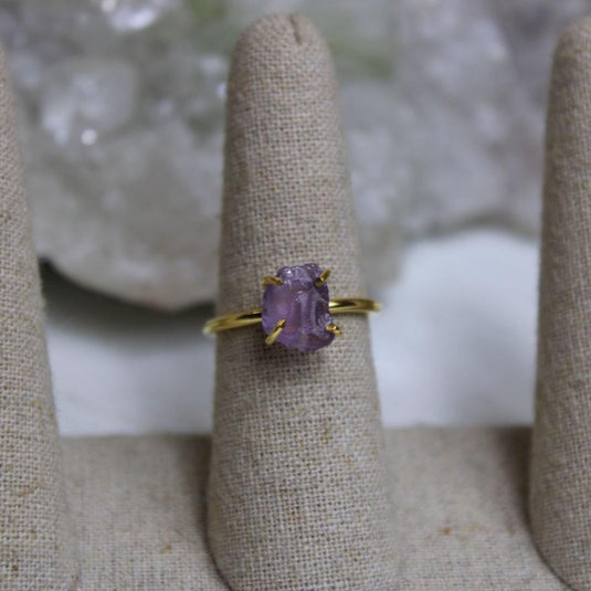 A close-up of a Raw Amethyst Ring set in 18ct gold vermeil on a ring stand