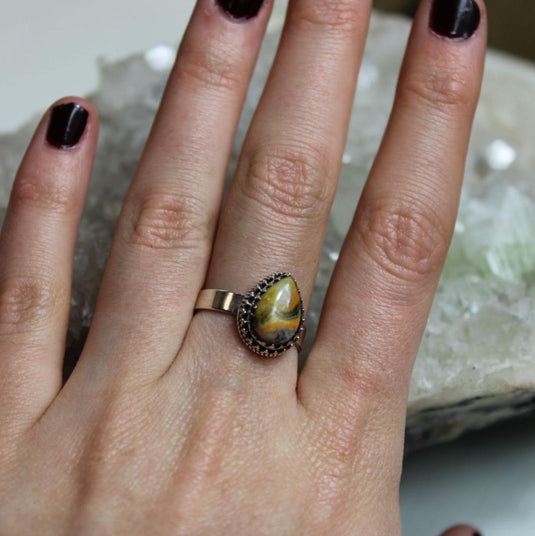 Unique Bumblebee Jasper gemstone ring, sterling silver setting, tear drop design, crystal background