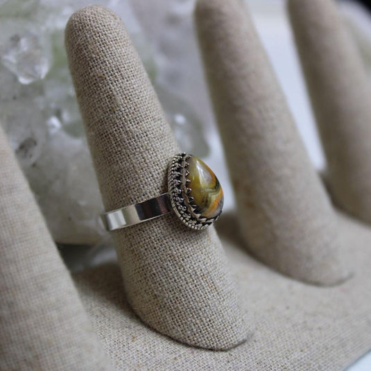 A stunning Bumblebee Jasper ring ready to be admired on a display stand.

