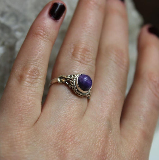 Purple Charoite gemstone ring on a hand