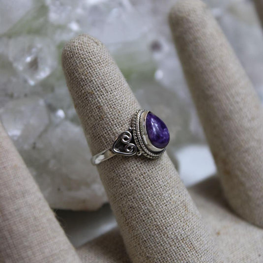 Charoite ring on a display finger