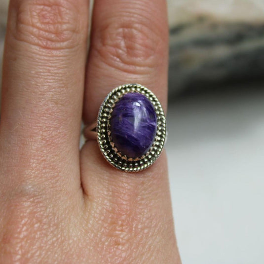 The captivating purple and lavender hues of the Charoite gemstone shine in this elegant silver ring.