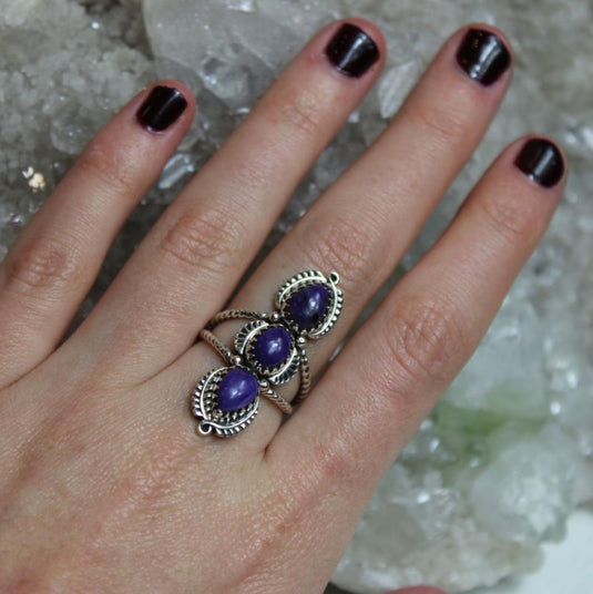 A beautiful charoite ring showcasing the mesmerizing purple hues and intricate patterns of the gemstones.