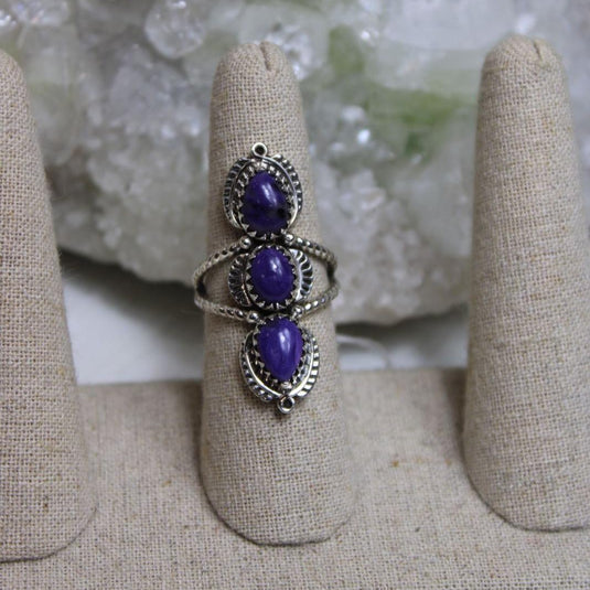 A beautiful charoite ring showcasing the mesmerizing purple hues and intricate patterns of the gemstones.