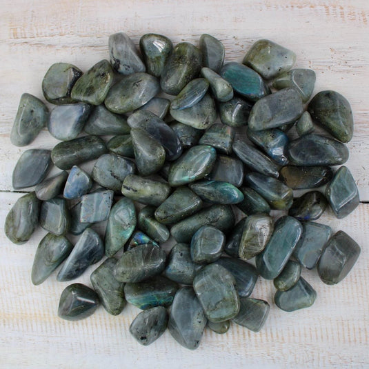 Labradorite Crystal Tumblestones on a White Wooden Background available at Keshet Crystals