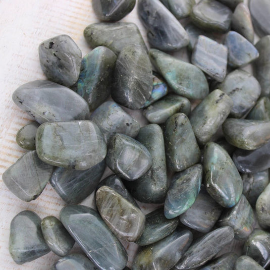 A close-up of Labradorite tumbled stones, showcasing their iridescent hues and smooth surfaces at Keshet Crystals in Petersfield