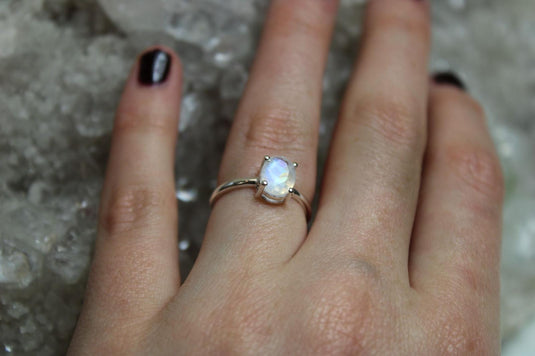 A prong setting moonstone sterling silver ring on a hand