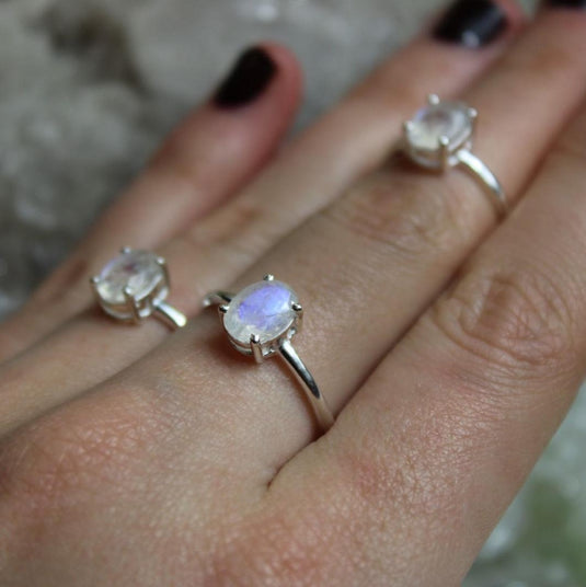 3 prong settings Moonstone sterling silver rings on a hand with black nails