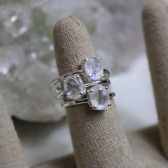 Delicate and ethereal moonstone rings stacked on a ring stand