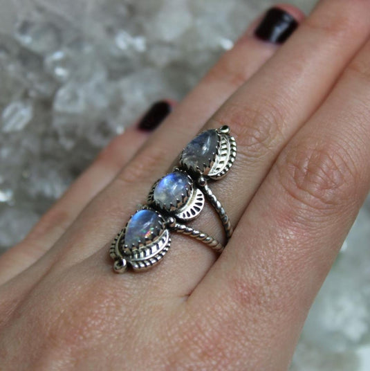 Delicate sterling silver ring featuring three tear drop-shaped moonstones with a soft, ethereal glow