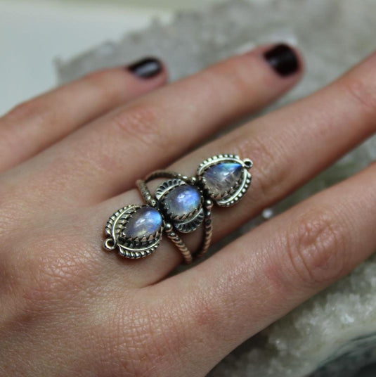 Bohemian-style ring with three tear drop-shaped moonstones, set in a twisted band with decorative accents