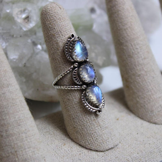 Trilogy moonstone ring on a ring stand