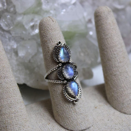 Trilogy moonstone ring showcasing the mesmerizing adularescence of the gemstones