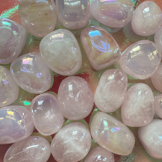 Aura Rose Quartz Tumblestones on an Iridescent Background