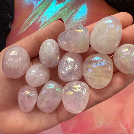 Aura Rose Quartz Tumblestones on a palm