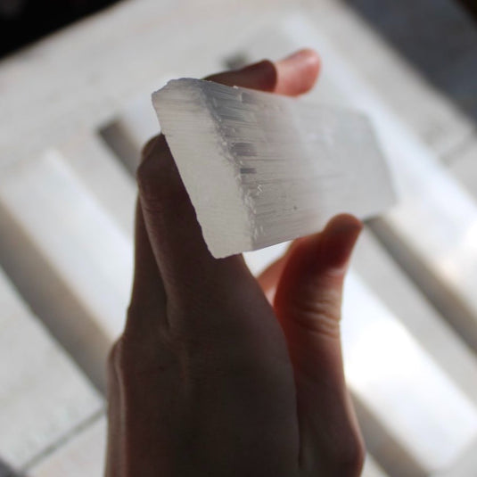 Selenite Ruler in Hand Close Up - Rough Crystals - Keshet Crystals in Petersfield