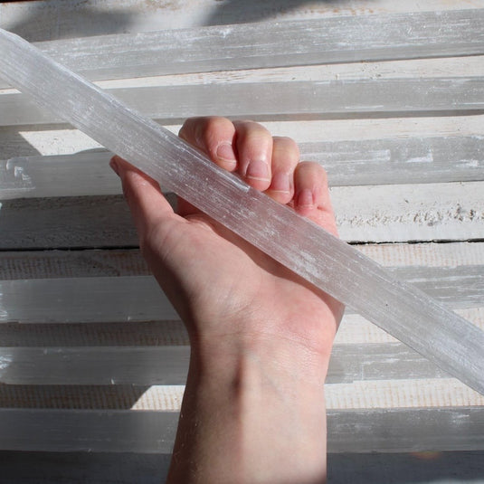 Raw Selenite Stick in Hand - Rough Crystals - Keshet Crystals in Petersfield